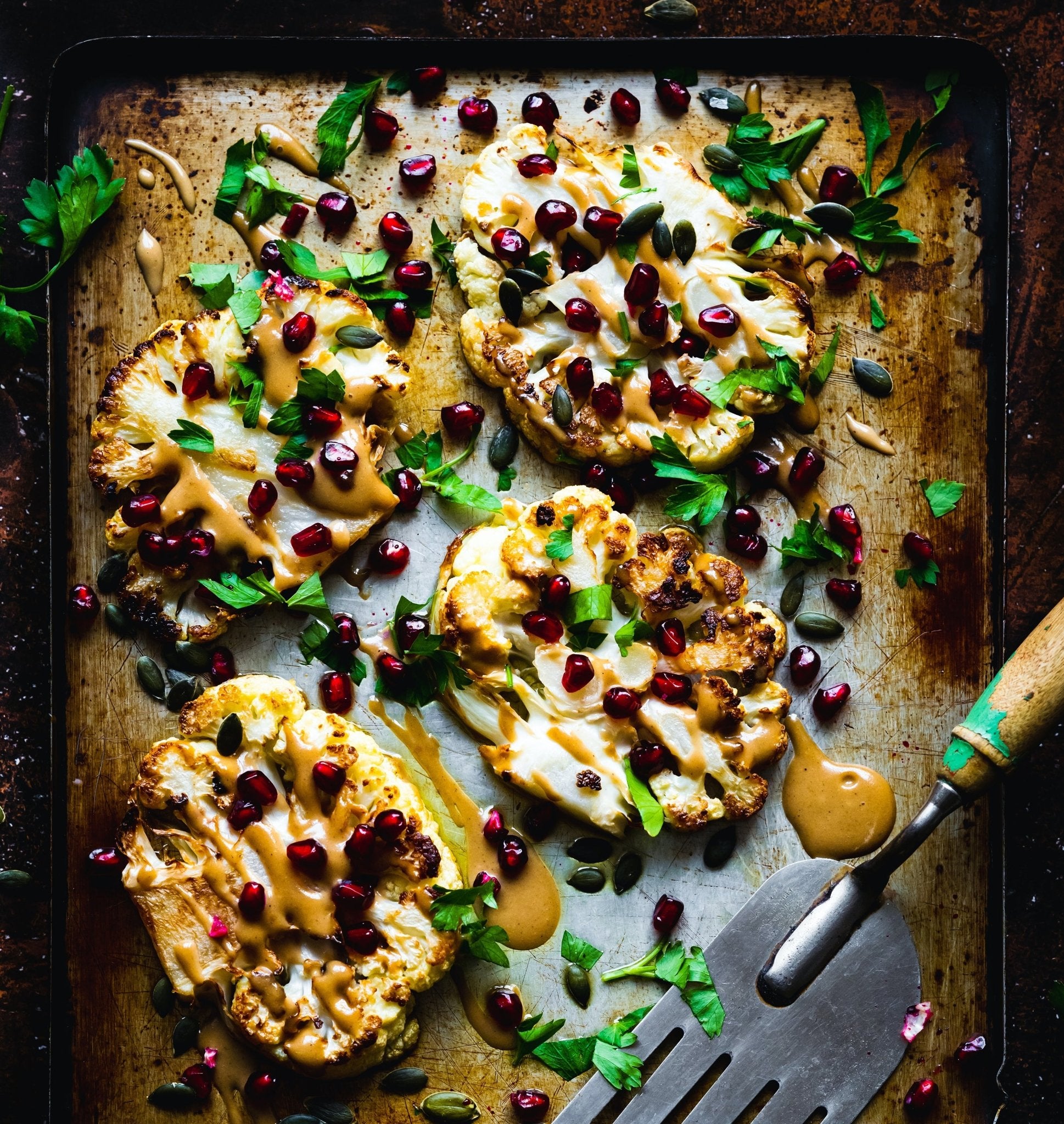 Cauliflower Steaks with Tahini Sauce, Pomegranate & Parsley - Lidia's